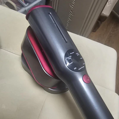 CreaseFree steamer standing on its base with the pink press plate visible